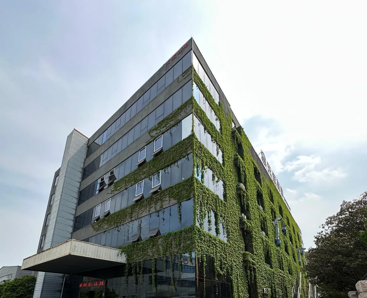 Multi-storey building covered in climbing ivy, with a Tianhong Lithium sign on the roofline